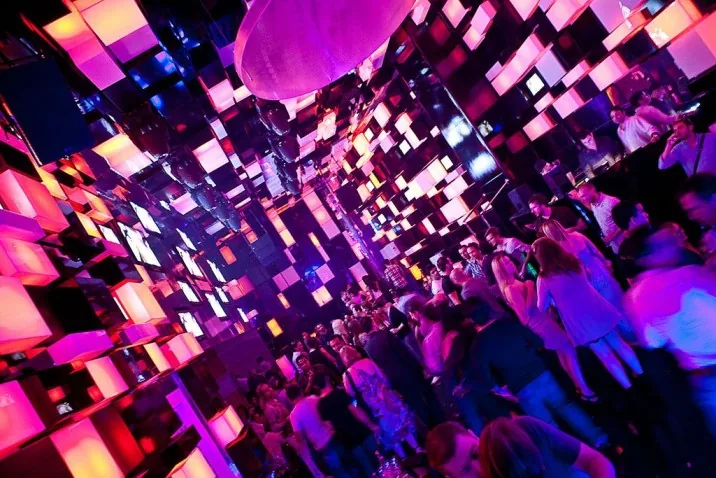 Packed dance floor under magenta LED cube walls at Chameleon Club Dubai
