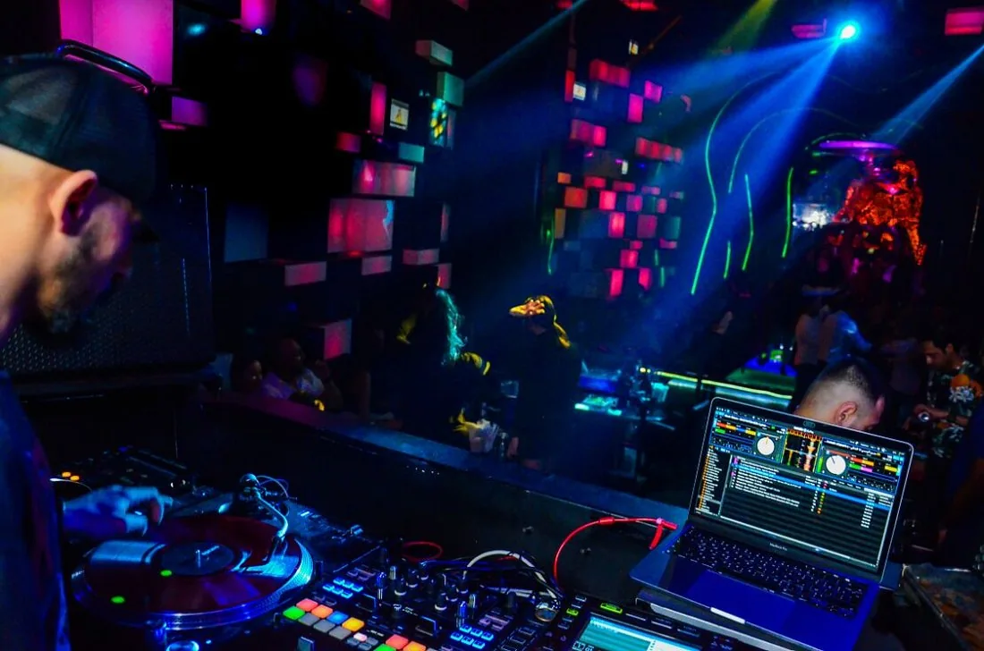 DJ booth at Chameleon Club Dubai with blue lasers and LED lighting