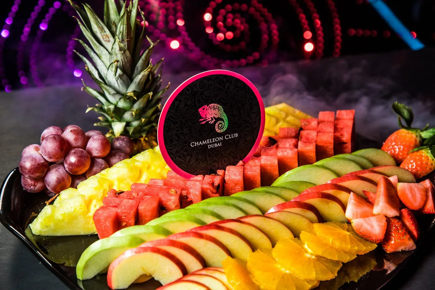 Signature fruit platter with Chameleon Club branding