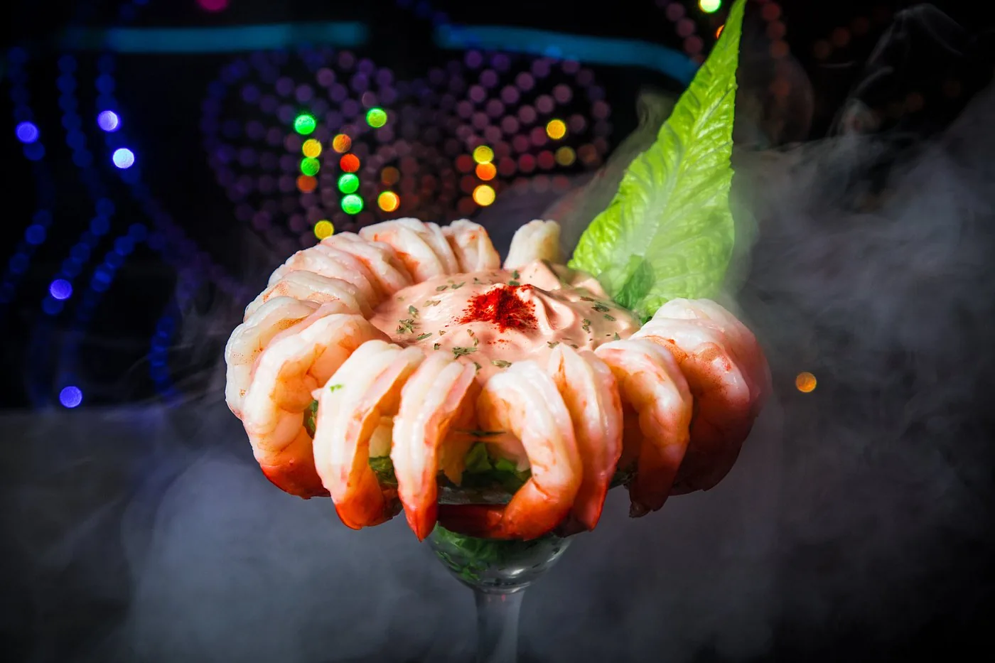 Chilled shrimp cocktail presented with dramatic smoke